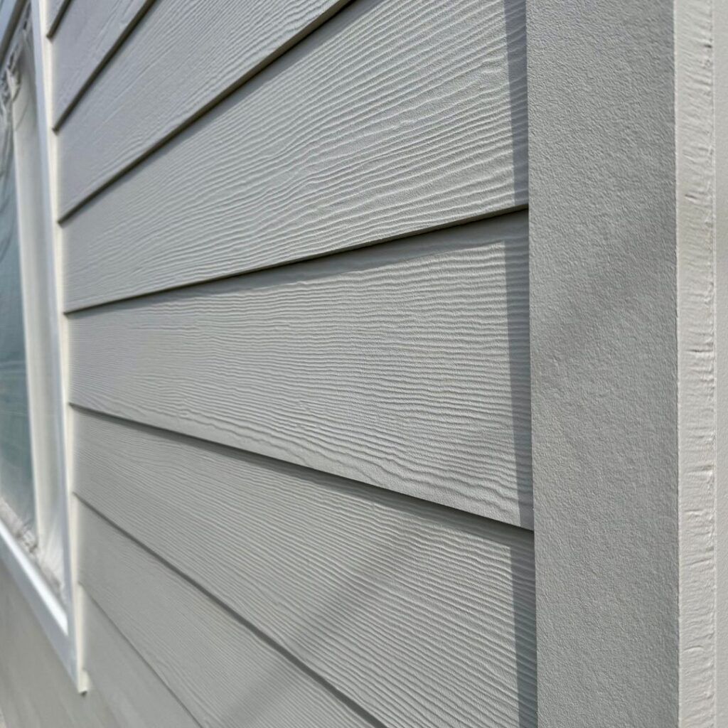 Close-up view of James Hardie fiber cement lap siding installed on a home exterior.