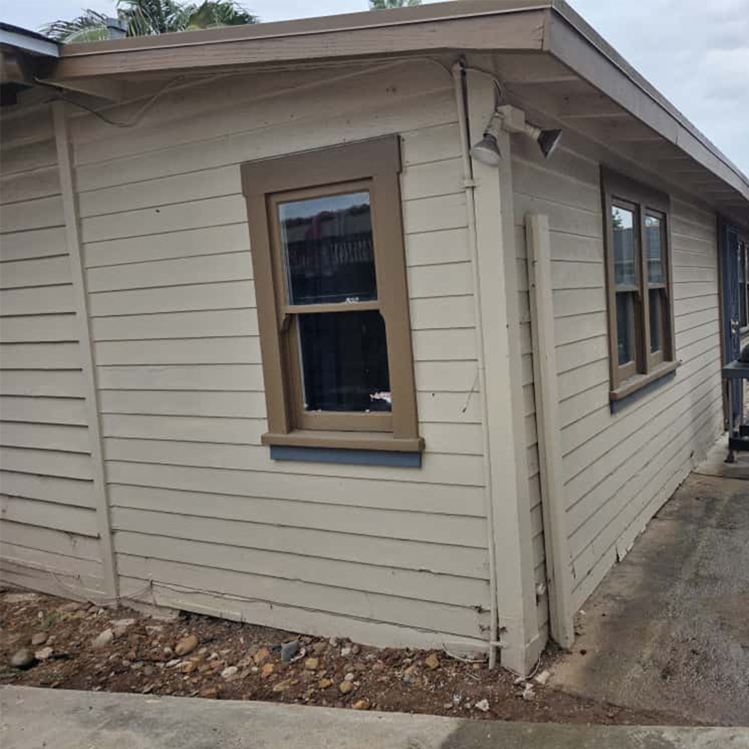 Warped siding damage coastal San Diego house.